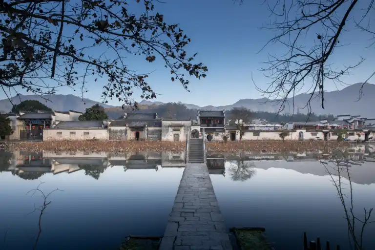 Traditional Chinese village, ancient village, misty mountains, tranquil lakes, traditional architecture, rich cultural heritage