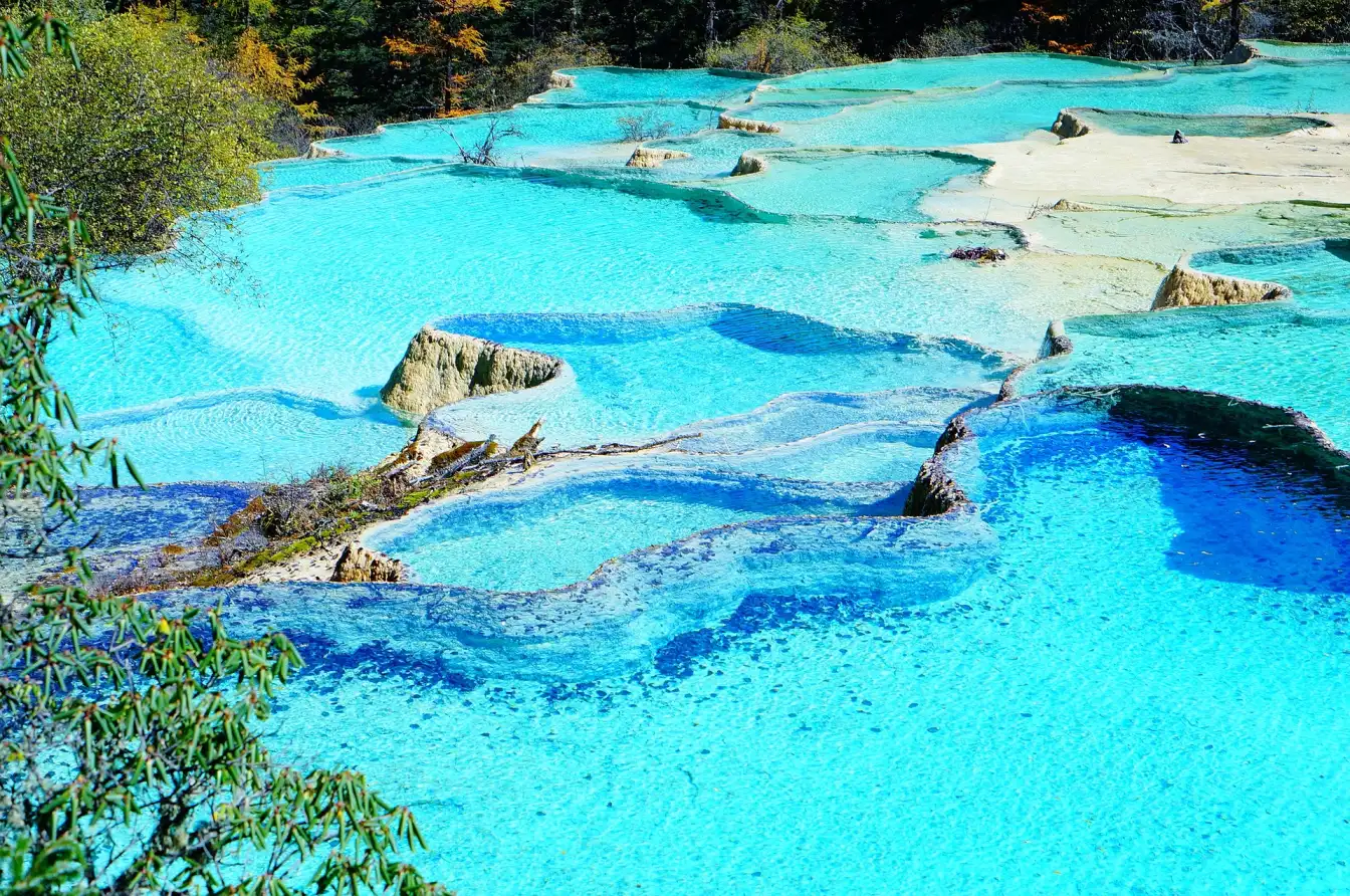 Huanglong Scenic Area, natural wonder, colorful pools, cascading waterfalls
